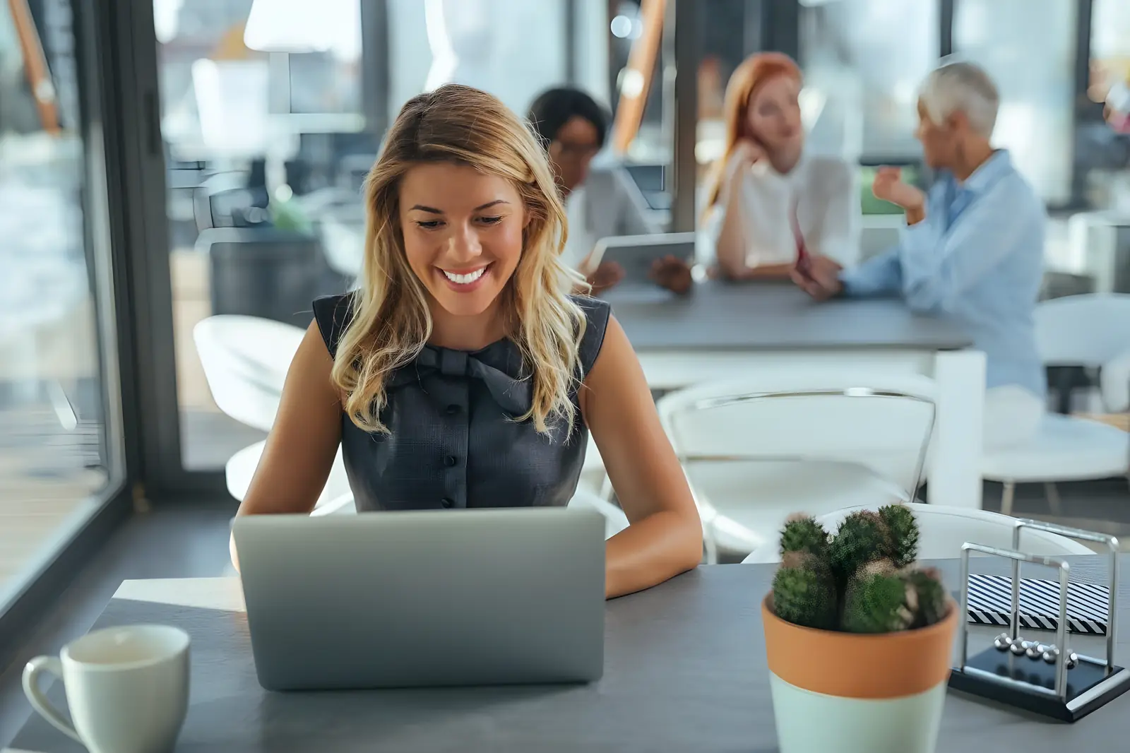 Professional smiling while working on a laptop