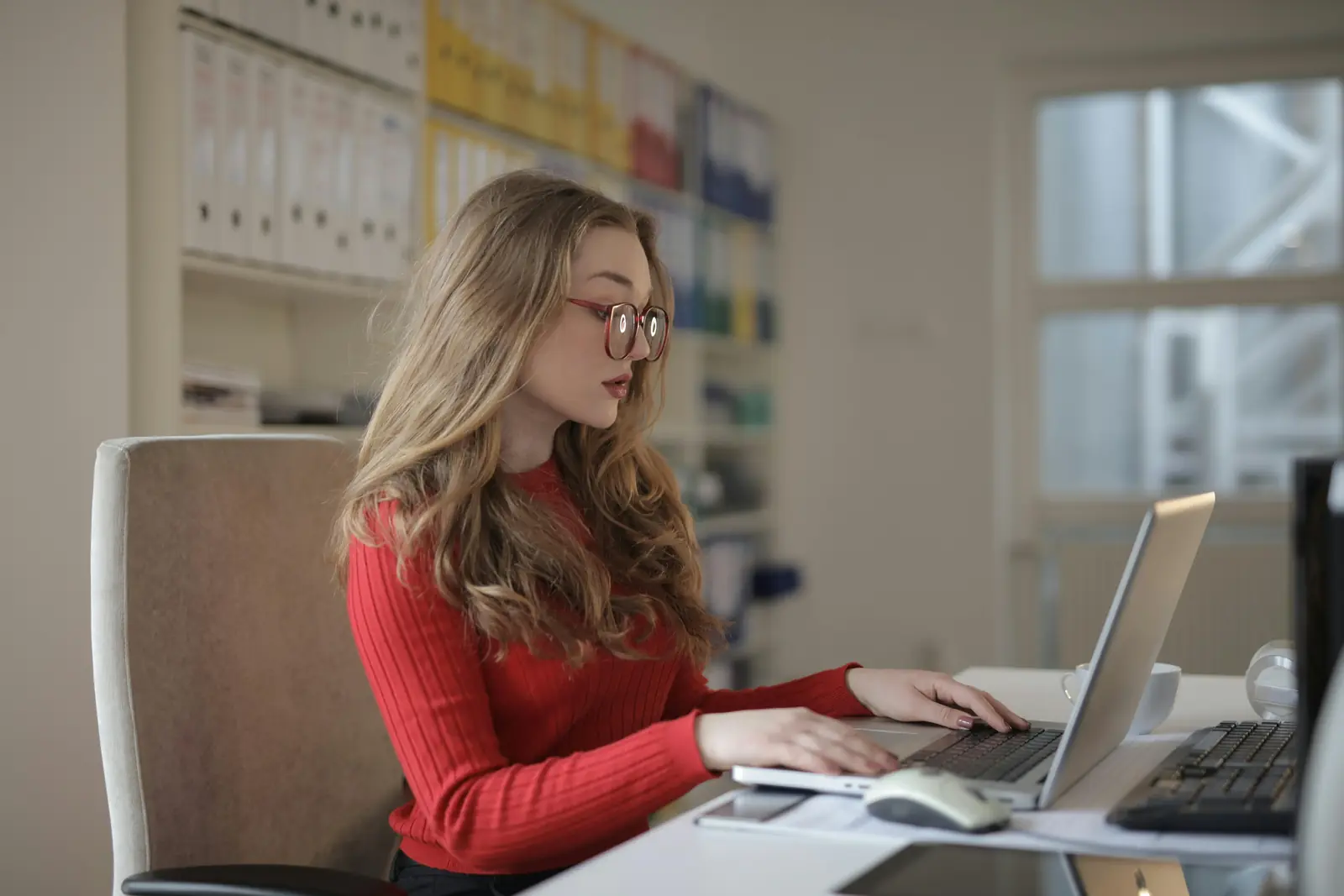Accountant working at a laptop in a bright office