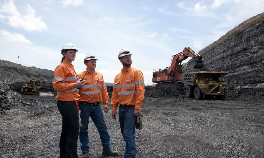 Mining technicians in safety gear at an open cut mine